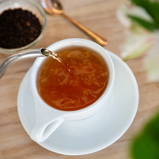 Pouring Toddy black tea into cup